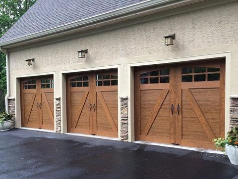 Three wood-look carriage garage doors